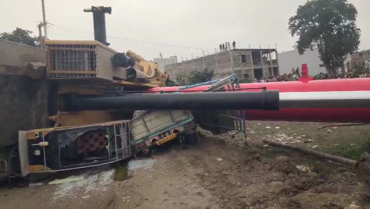 Crane falls from under-construction railway bridge